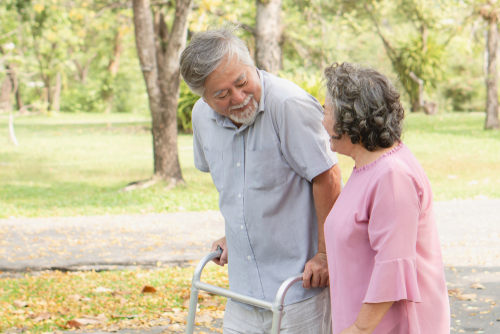 An older couple walking together outdoors
